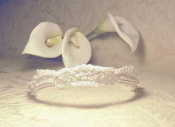 Elegant couture Alen�on lace tiara with hand sewn pearls and sequins.